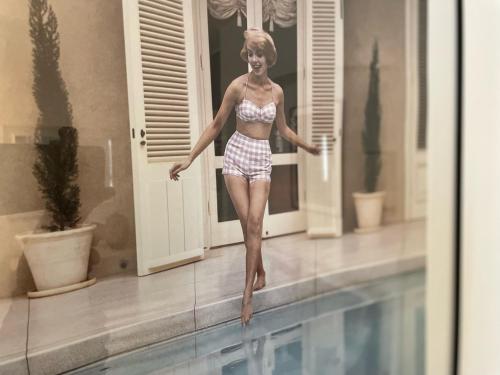 une femme en bikini debout à côté d'une piscine dans l'établissement Nice Renting - BONAPARTE - Luxury Loft Trendy neighborhood - AC - fully equipped, à Nice