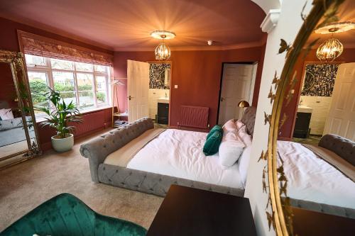 a bedroom with a large bed and a couch at Little Hayes in Lyndhurst