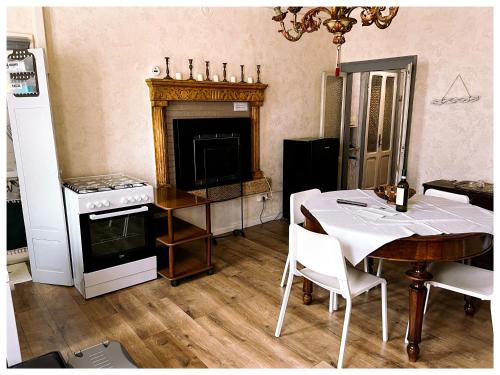 a living room with a table and a stove at Casale storico Enzo in Castelnuovo del Garda