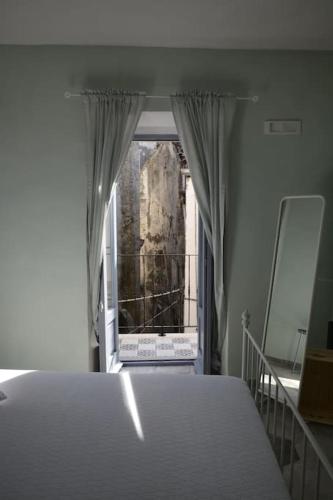 a bedroom with a large bed and a window at GarganoMareBorghi ospitalità diffusa in Vico del Gargano