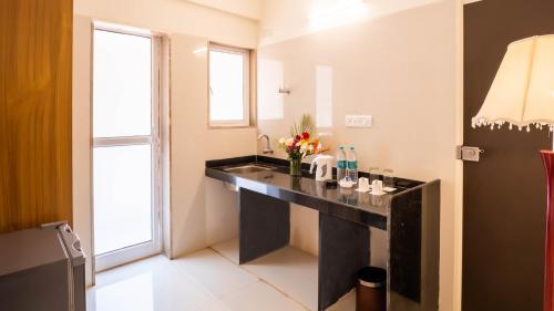 a bathroom with a sink and a large window at Hotel Reemz Beach Heaven , Anjuna in Anjuna