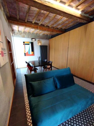 a living room with a blue couch and a table at The View - Sunset & Relax - Suite - Appartamenti Vista Lago in Passignano sul Trasimeno