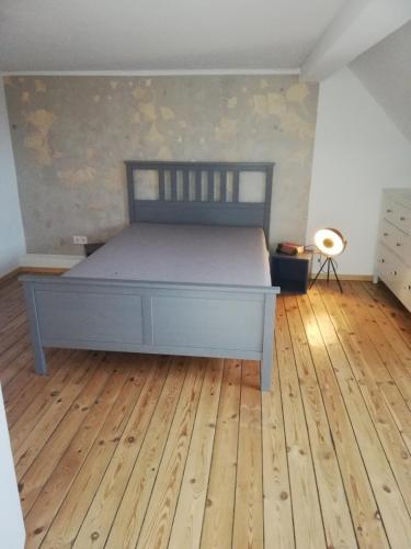 a bedroom with a bed and a wooden floor at Strandhaus in Neubukow