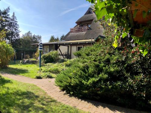 a house with a walkway in front of a yard at Haus 1795 Specht in Wustrow