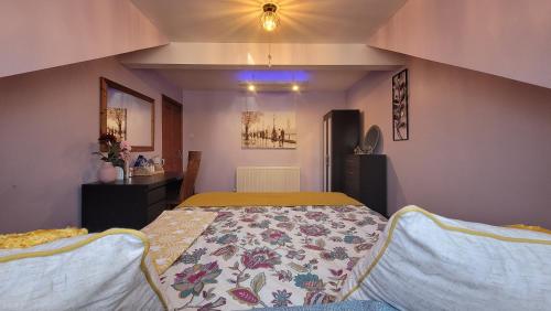 a bedroom with a large bed with a colorful blanket at Another sweet home in Bradford