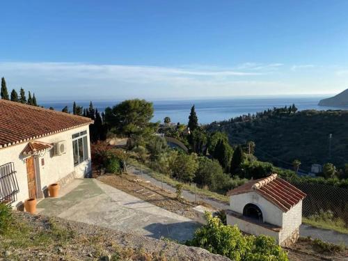 a small house on a hill with a view of the ocean at Villa Eugenia in La Herradura