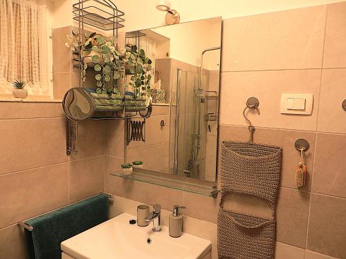 a bathroom with a sink and a mirror at VillaV, seafront 2-story 4* apartment with great outdoors in Prizba