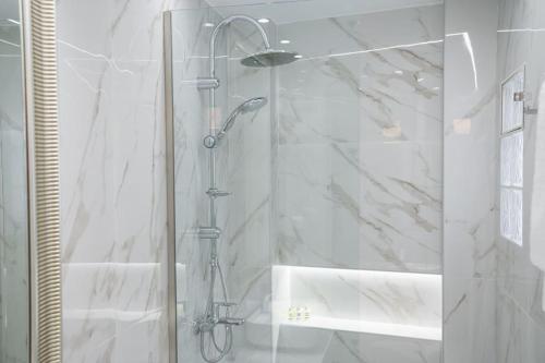 a shower with a glass door in a bathroom at The Keys in Kastoria