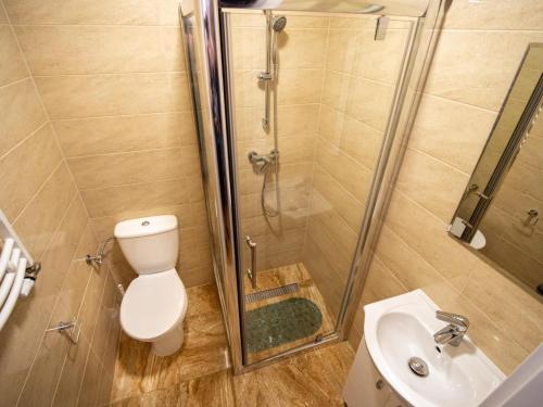 a bathroom with a shower and a toilet and a sink at GRANDIAL in Władysławowo