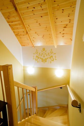 a staircase in a house with a wooden ceiling at Domki Kaszuby - jezioro las i zoo w Szarlocie in Kościerzyna