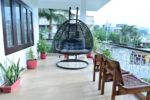 a room with a hanging chair on a balcony at Dhairya's Villa Home Away From Home in Jammu