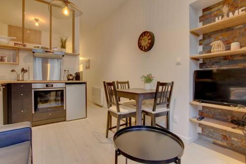 a kitchen and dining room with a table and chairs at Le Rousseau - Beautiful studio in Old Town in Annecy