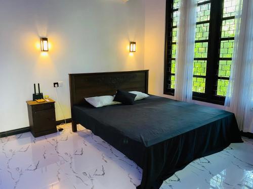 a bedroom with a large bed and a window at Green House Resort in Sigiriya