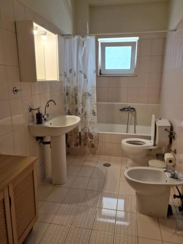a bathroom with a toilet and a sink at Maria's Sharing Apartment in Heraklio