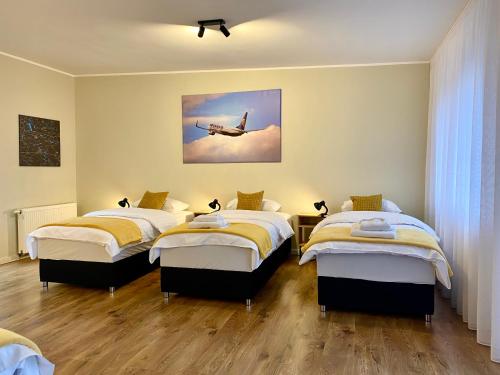 a bedroom with two beds and a plane in the sky at Yose Apartment - 160 m2 na wyłączność in Poznań