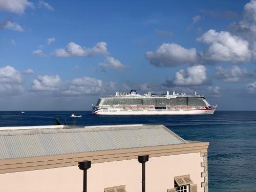 a large cruise ship in the ocean on the water at Carib Edge, AC beach penthouse in Saint Peter