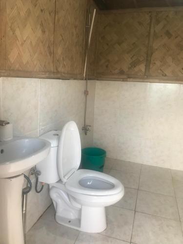 a bathroom with a toilet and a sink at Bayview Coron Kawa Resort in Coron