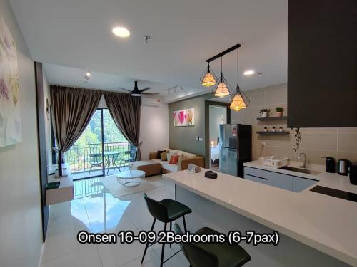 a kitchen and a living room with a kitchen and a living room at Ipoh Sunway Onsen Suites and Tambun Guesthouse , 3-14pax 2parking by IWH in Ipoh