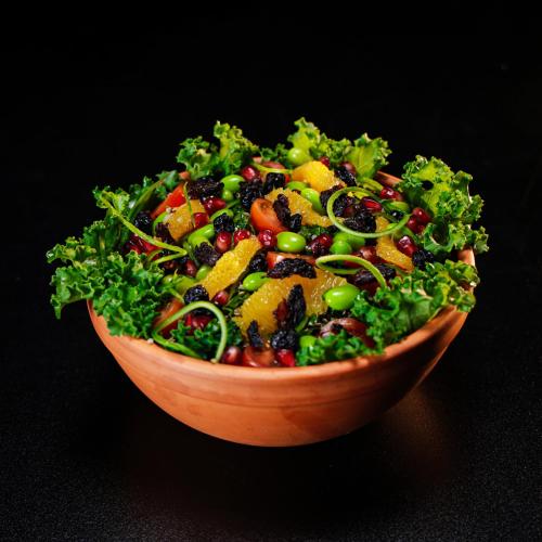 a salad in a wooden bowl on a table at Le Caravelle Beirut in Beirut