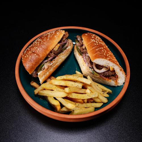 a blue plate with a sandwich and french fries at Le Caravelle Beirut in Beirut