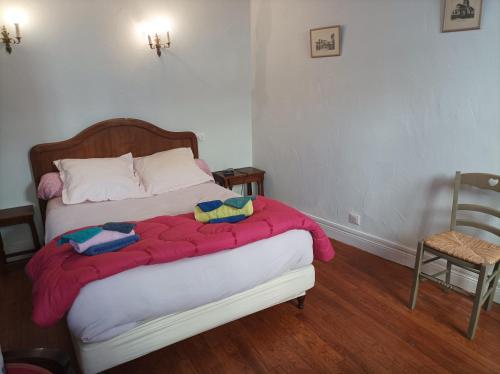 a bedroom with a bed with a red blanket on it at Au coeur de la cité des Bourbons in Moulins