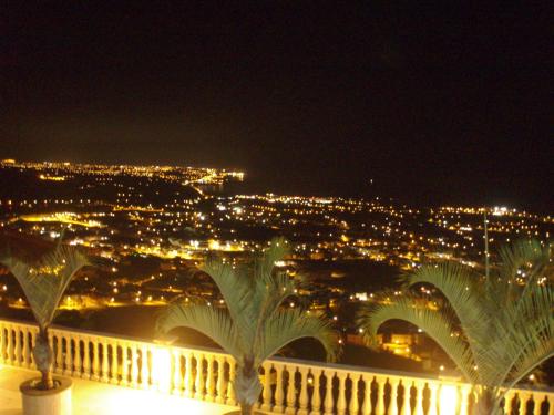 a view of a city at night with lights at BREATH TAKING SEAVIEW VILLA in Peyia