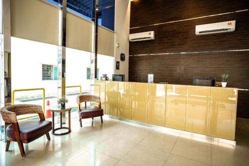 a lobby with chairs and a table in a building at PP Hotel by Moxy in George Town