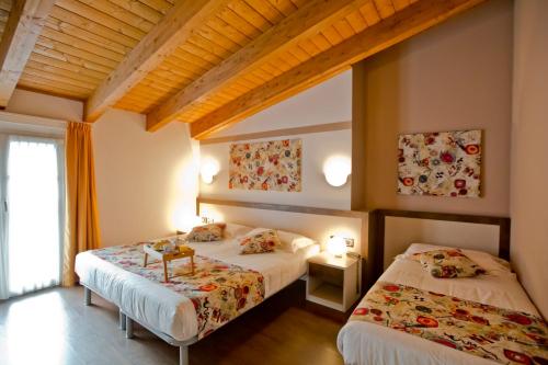 Postel nebo postele na pokoji v ubytování Hotel Lago di Como