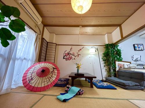 a room with two umbrellas on the floor at Shinjuku Shin-Okubo Station Nippon no Yado in Tokyo