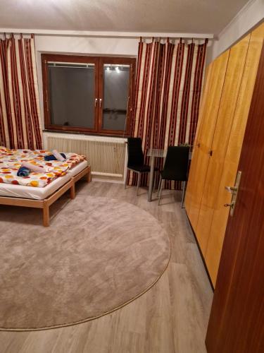 a bedroom with a bed and a large window at DrKarlRennerGarten in Guntramsdorf