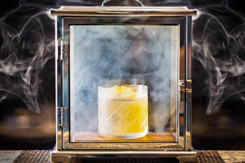 a picture of a glass with a drink with smoke at Houston CityPlace Marriott at Springwoods Village in The Woodlands