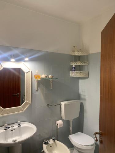 a bathroom with a white toilet and a sink at Olimar Sea View Apartment in Albufeira