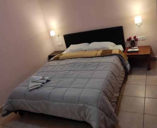 A bed or beds in a room at Nikolettas Studios Traditional House