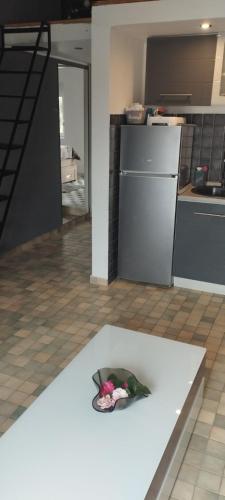 a kitchen with a white counter with flowers on it at Budva stan Natasa in Budva
