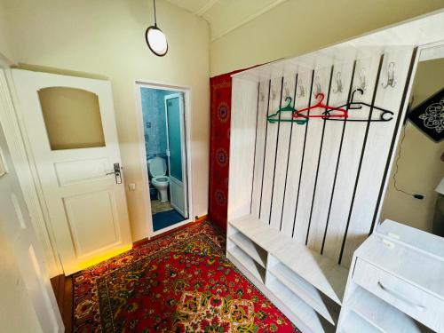 a room with a door with skis on the wall at Nemo Guest House in Bukhara