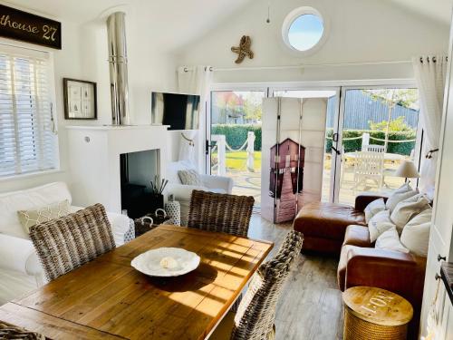a living room with a table and a couch at Boardwalk@TheBay, Filey in Filey