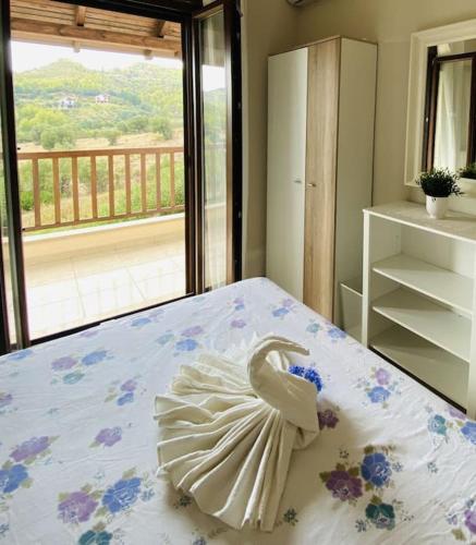a swan decoration on a bed in a bedroom at Villa Oceanview Vicky in Pefkochori