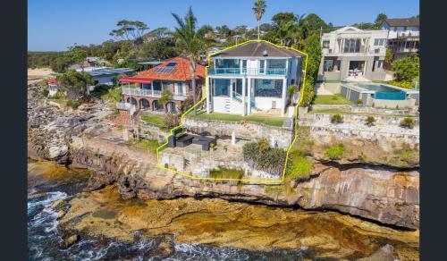 an aerial view of a house on a cliff at Bundeena Waterfront Pavilion in Bundeena
