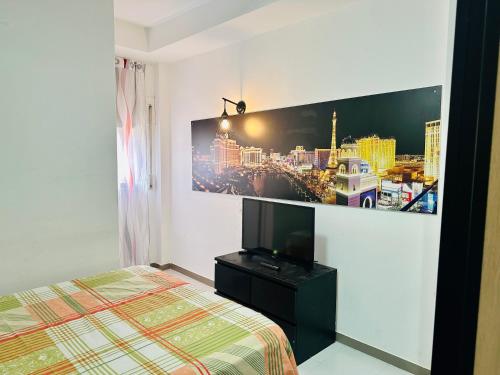 a bedroom with a bed and a picture of a city at Habitación in Madrid