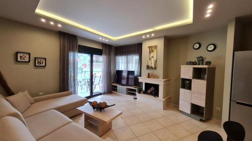 a living room with a couch and a tv at Toroni Pearl in Toroni