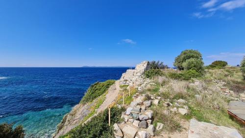an old stone wall next to the ocean at Toroni Pearl in Toroni