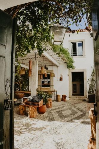an entrance to a white building with a patio at LEGASEA - Cascais Guesthouse in Cascais