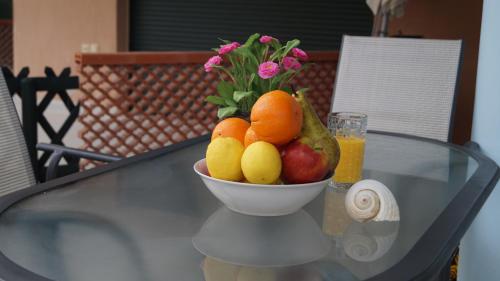 a bowl of fruit on top of a glass table at Toroni Pearl in Toroni