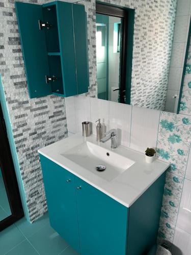 a bathroom with a sink and a mirror at Casa TimEva Azuga in Azuga