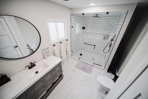 a bathroom with a shower and a sink and a mirror at Cozy 2-bedroom space in the heart of wine country! in Jordan