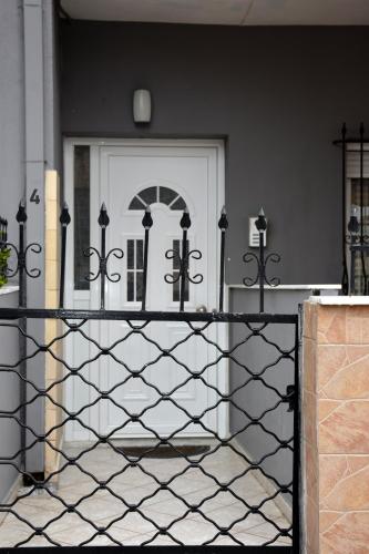 a black fence in front of a white door at Bella Vista in Kavála