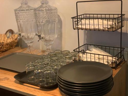 a counter with plates and glasses on a table at Locanda Museum Hotel in Giza