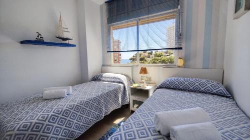 Posteľ alebo postele v izbe v ubytovaní BENICALA sea view apartment