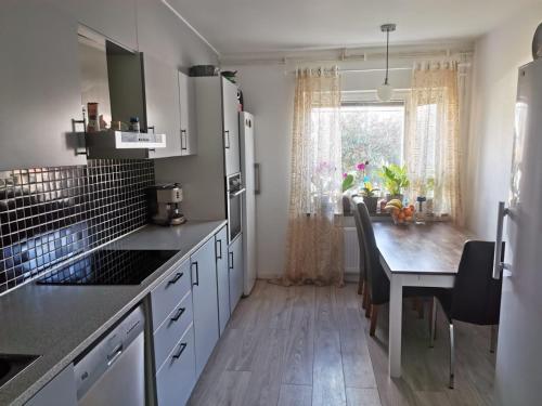 a kitchen with a table and a dining room at Villa i Ruda Högsby kommun in Ruda