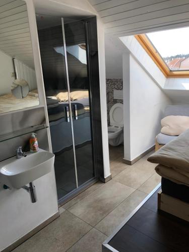 a bathroom with a sink and a bedroom at Apartman Kryštof in Františkovy Lázně